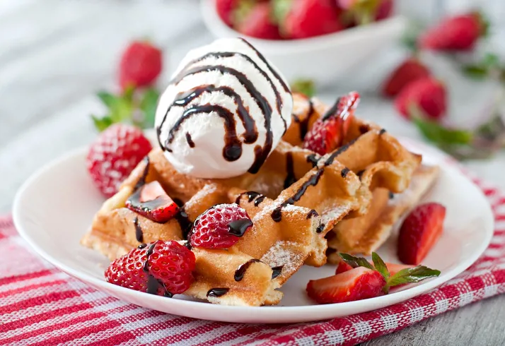 Belgium Waffles With Strawberries And Ice Cream On White Plate